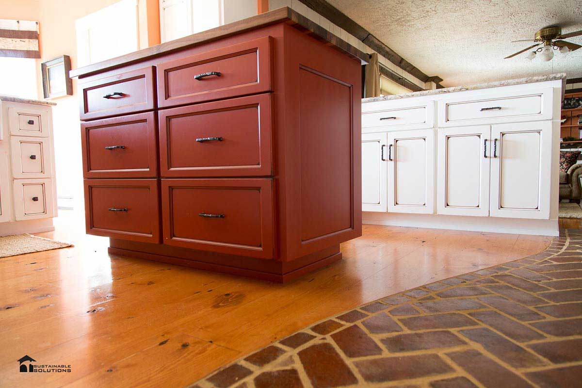 Custom kitchen Custom kitchen island Glazed cabinets Plank wood floors Custom brick flooring