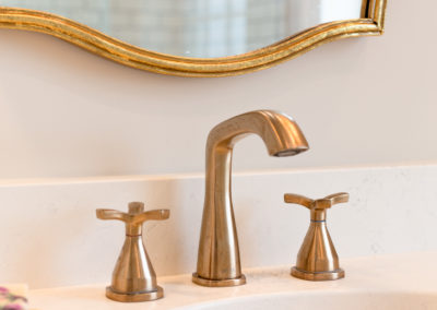Detailed shot of sink faucet and mirror frame